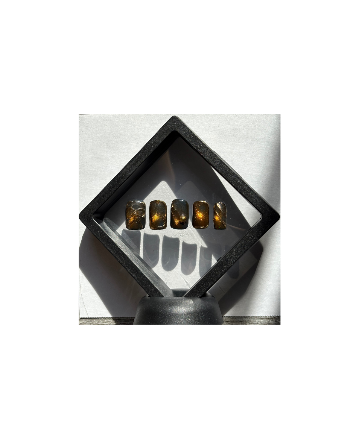 A luxury press-on nail collection inspired by traditional South Indian Sari craftsmanship. Featuring 3D gold scrollwork on a rich espresso base, these nails transition from wearable art to a preserved keepsake in our Heritage Archive.