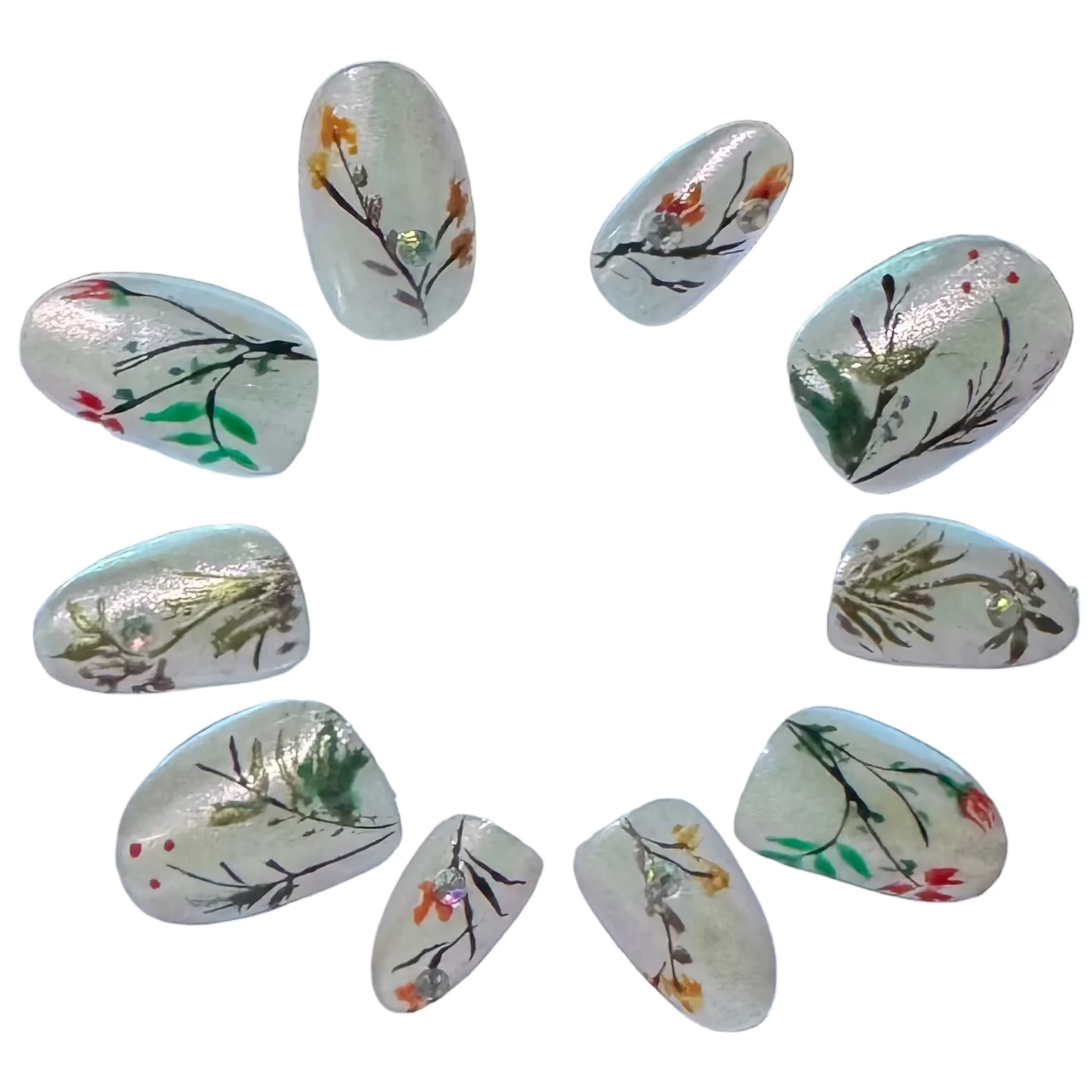 A milky white base with pearl finish gives it the muse of a Chinese garden. We’ve hand-painted thin, dark stems and small colorful buds across the nails to mimic early spring growth. A few small crystals are added to catch the light, like water droplets. It’s a simple, honest design for those who want a professional look that feels light and seasonal.