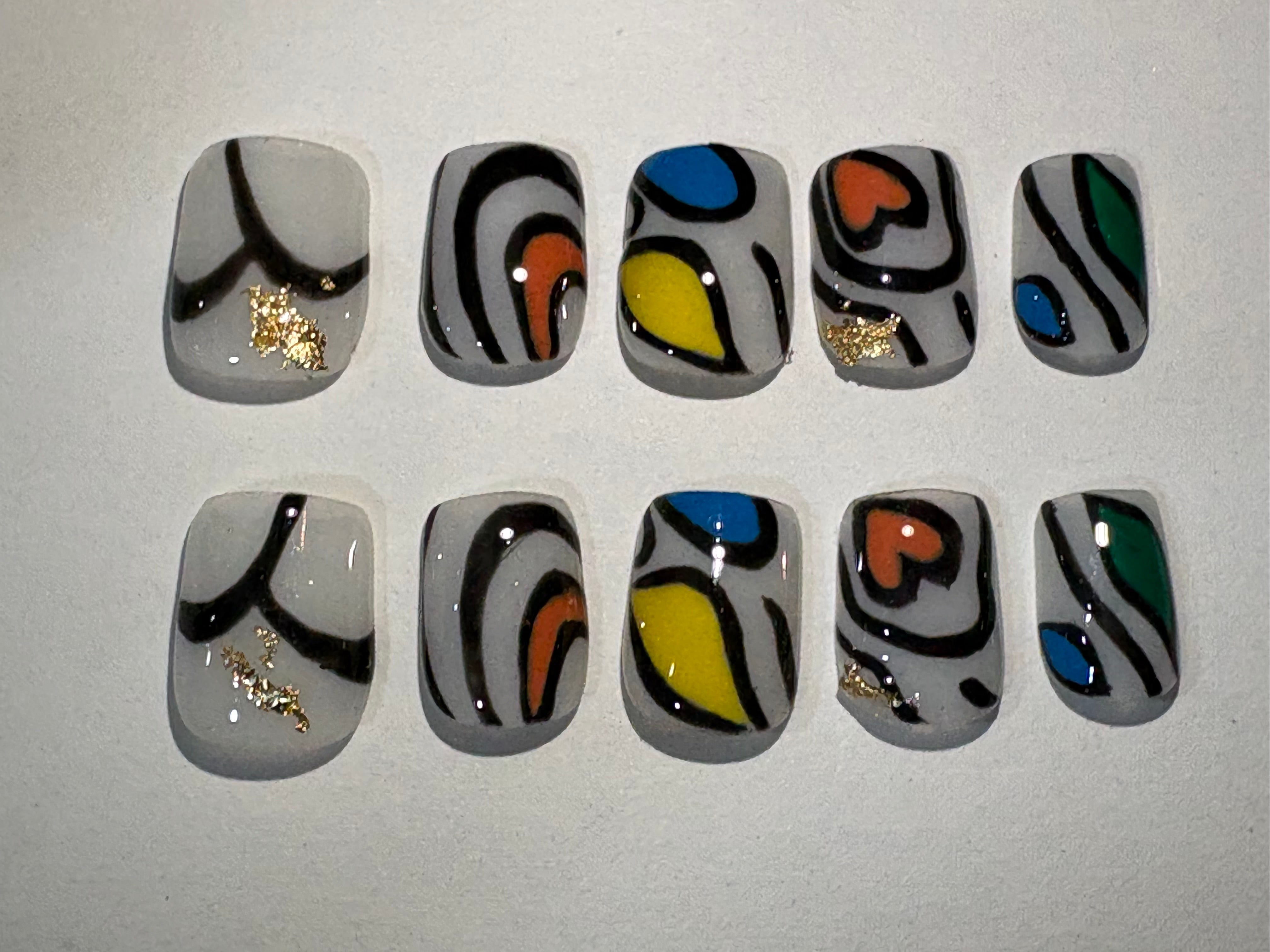 Milky white base with bold colors of red, yellow, blue and green with contours mimicking Kente weaving