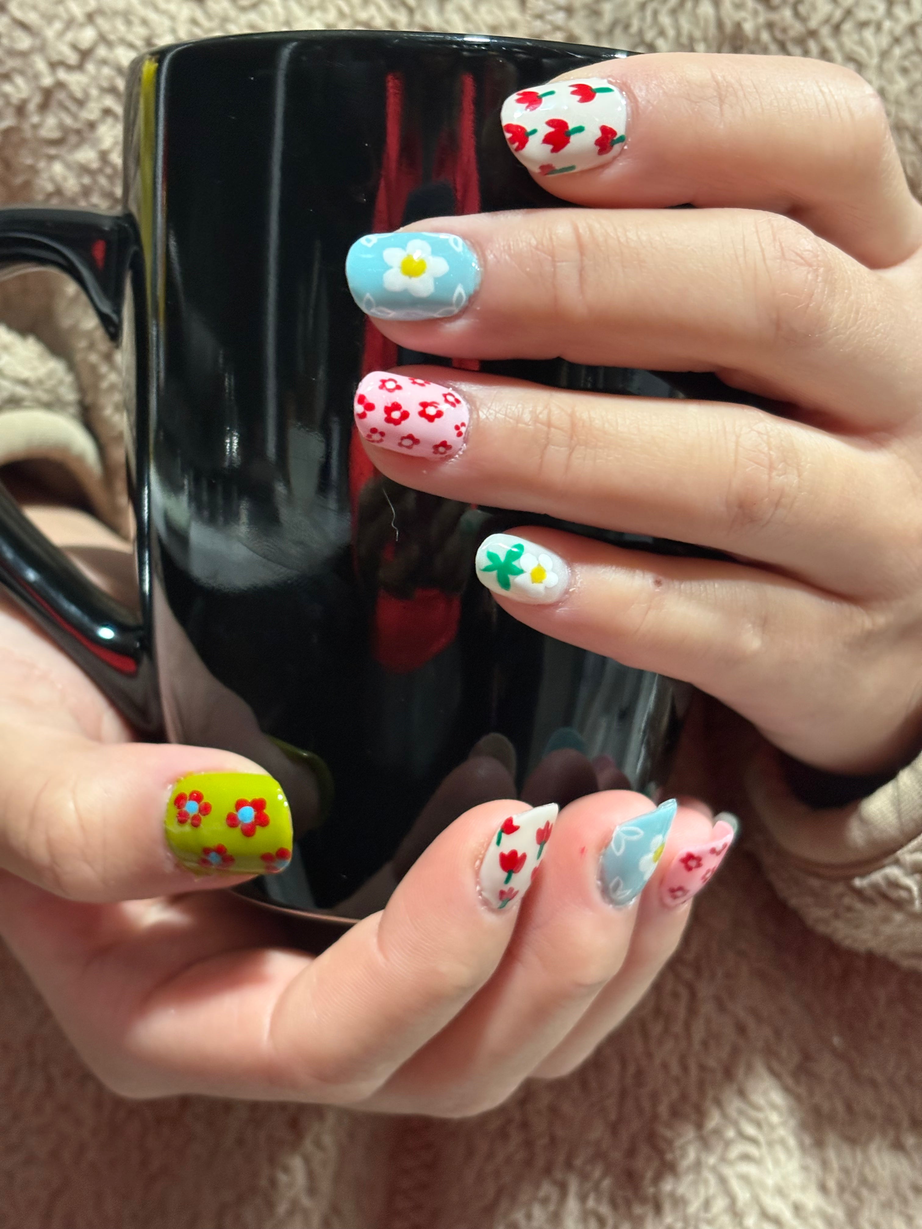 Multicolored flowered for valentine. Round shaped soft gel nails