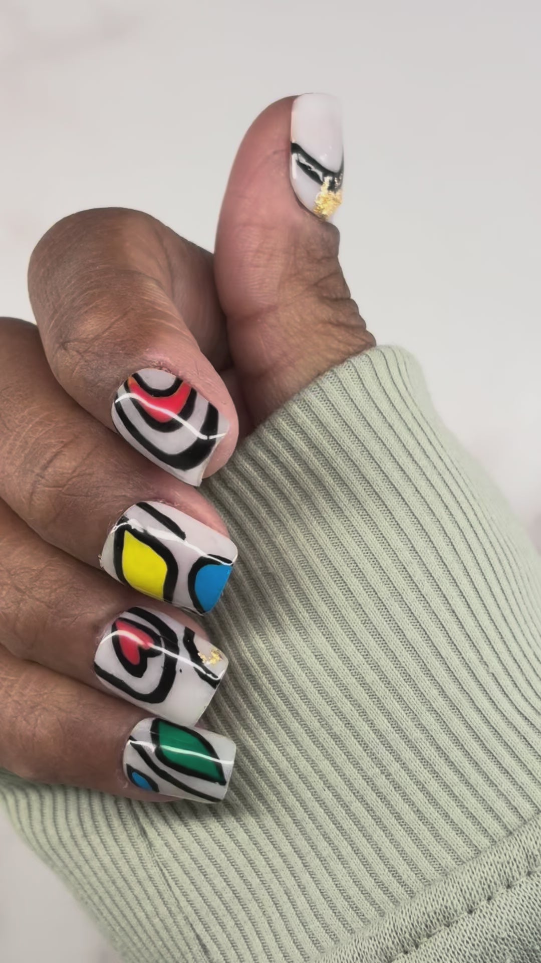 This design reimagines the traditionally rigid, geometric lines of Kente cloth as fluid, organic shapes defined by bold black boundaries. The palette of sun yellow, deep azure, and forest green is layered over a neutral base, accented with subtle gold leaf to mirror the silk threads found in royal textiles. 