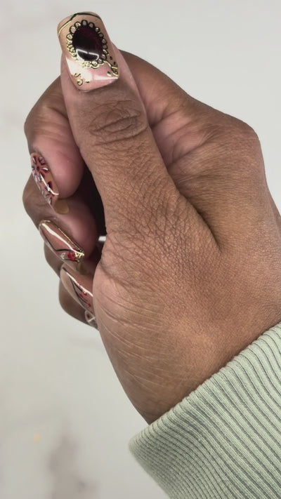 Hands showing  intricate art work of forts and mansions, these artisanal nails contains gel paint work and chrome. 