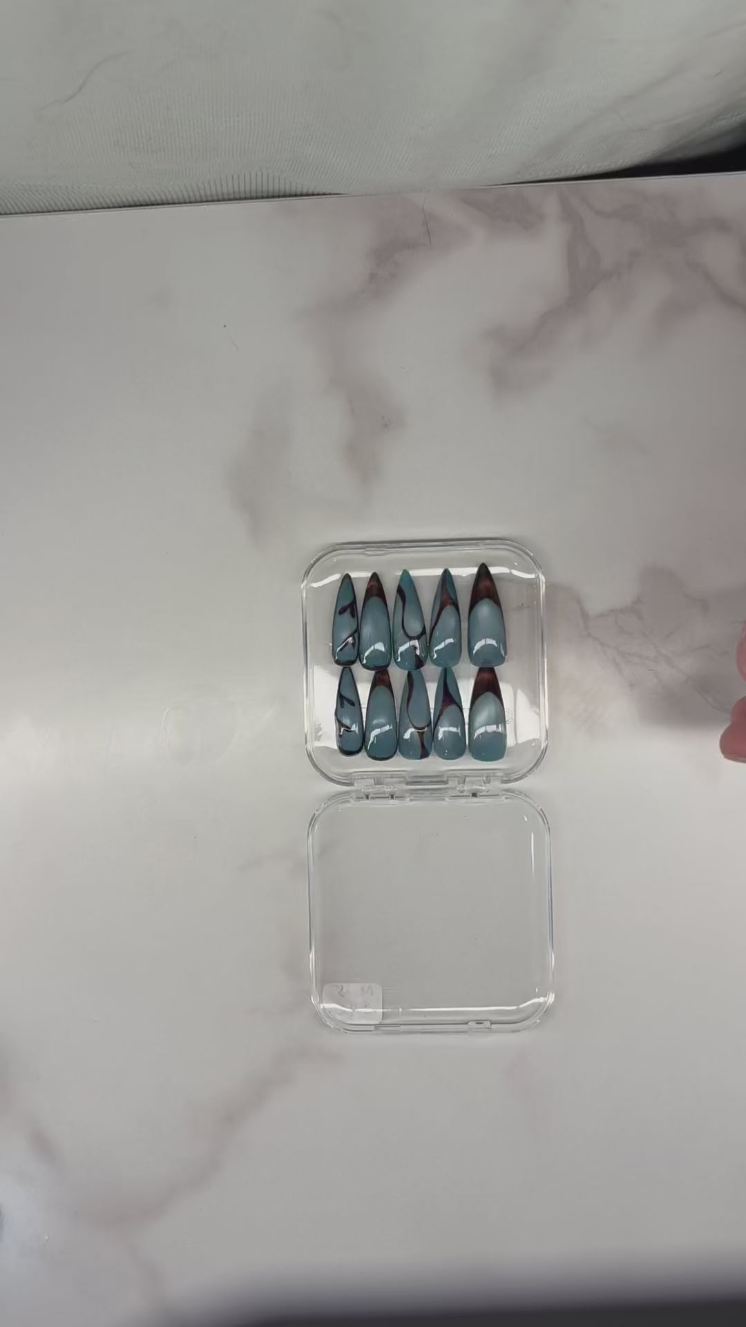 Blue and brown nails with aura and cateye press-on application on natural nails