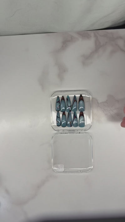 Blue and brown nails with aura and cateye press-on application on natural nails